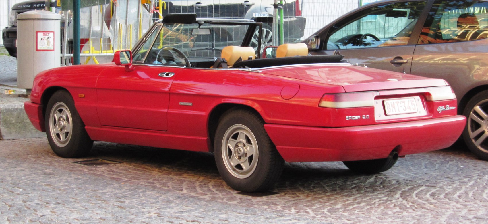Red convertible with beige interior and alloy wheels
