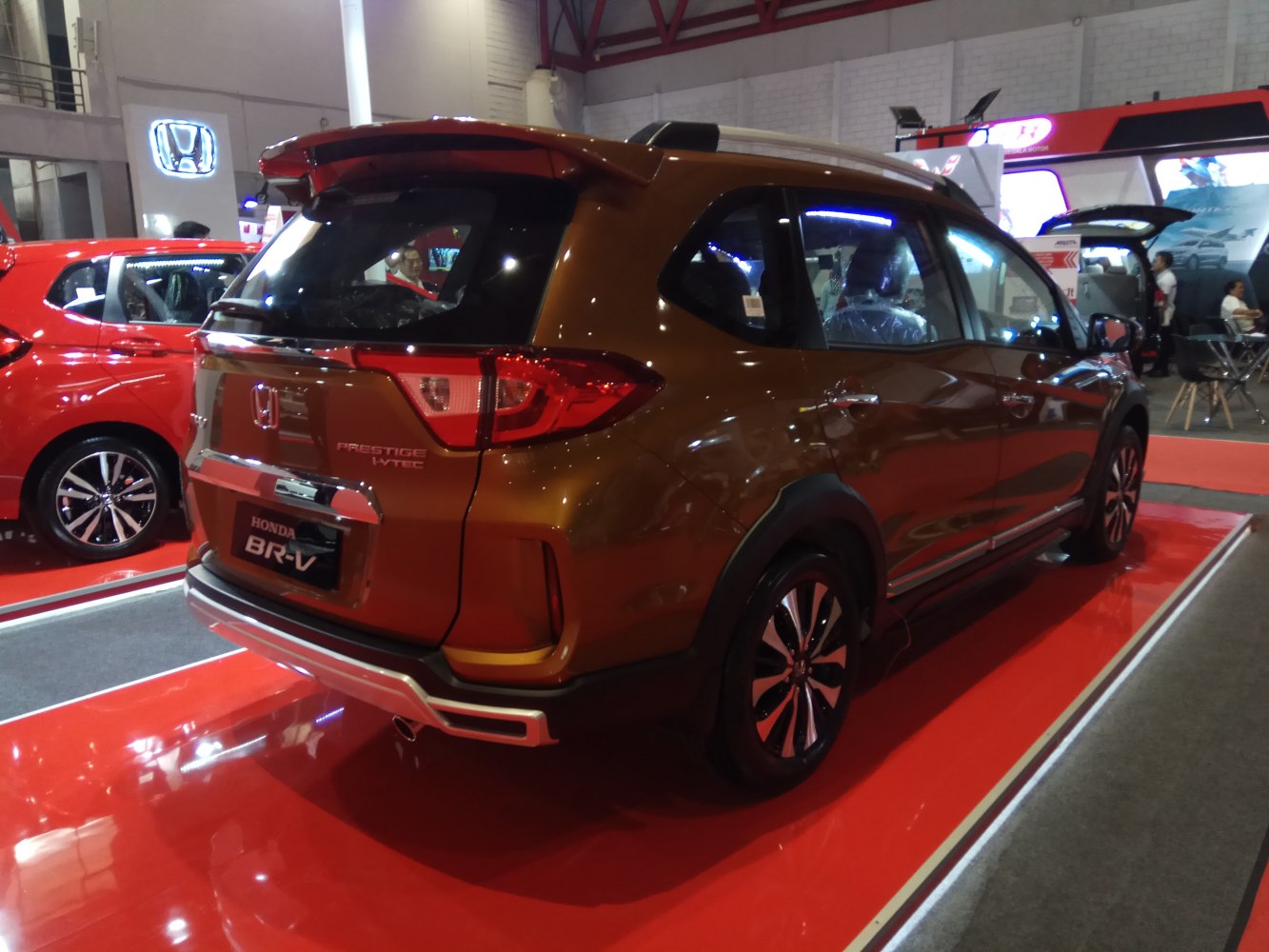 Rear and side view showcasing tail lights and roof spoiler