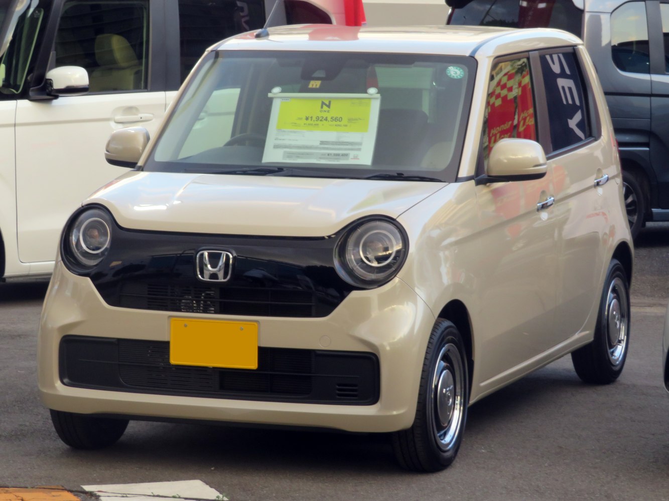 Compact hatchback with round headlights and black grille front