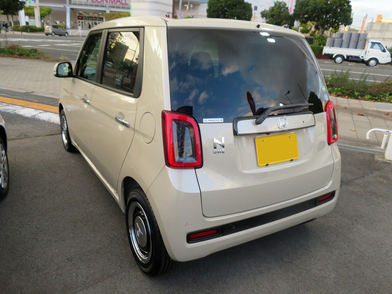 Compact hatchback rear with square tail lights and rear window wiper.
