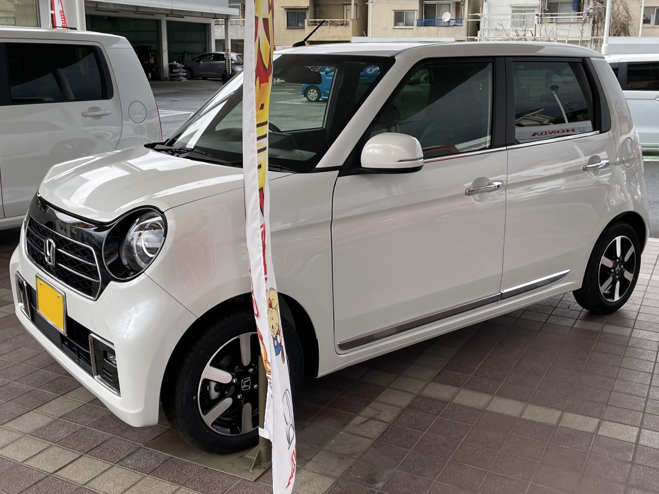 Compact kei car with round headlights and sleek side profile