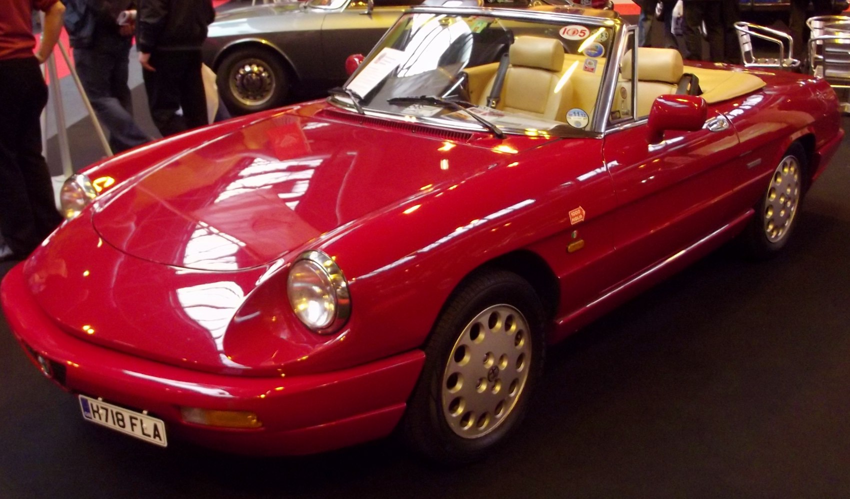 Red convertible with round headlights and alloy wheels