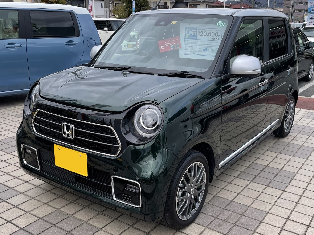 Compact car with round LED headlights and chrome grille front view