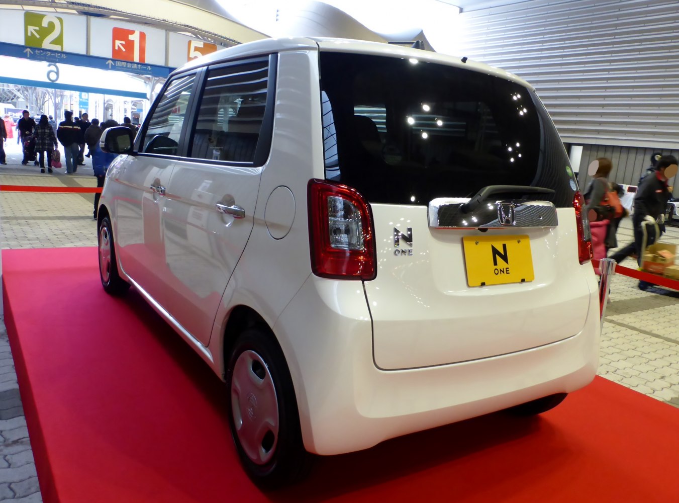 Rear view of compact kei car with boxy shape and distinctive taillights