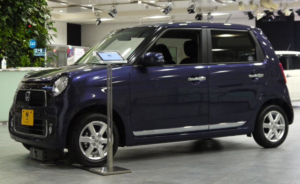 Compact kei vehicle with round headlights and boxy design