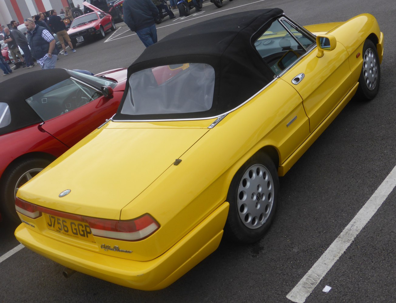 Yellow convertible with black soft top and classic rear design