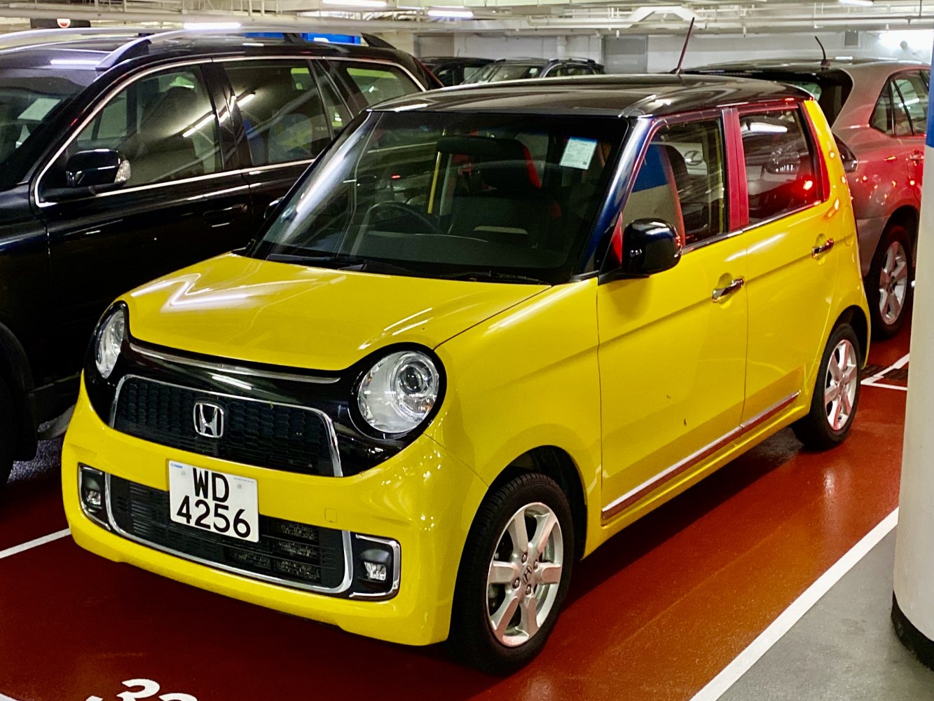 Compact yellow hatchback with round headlights and two-tone roof