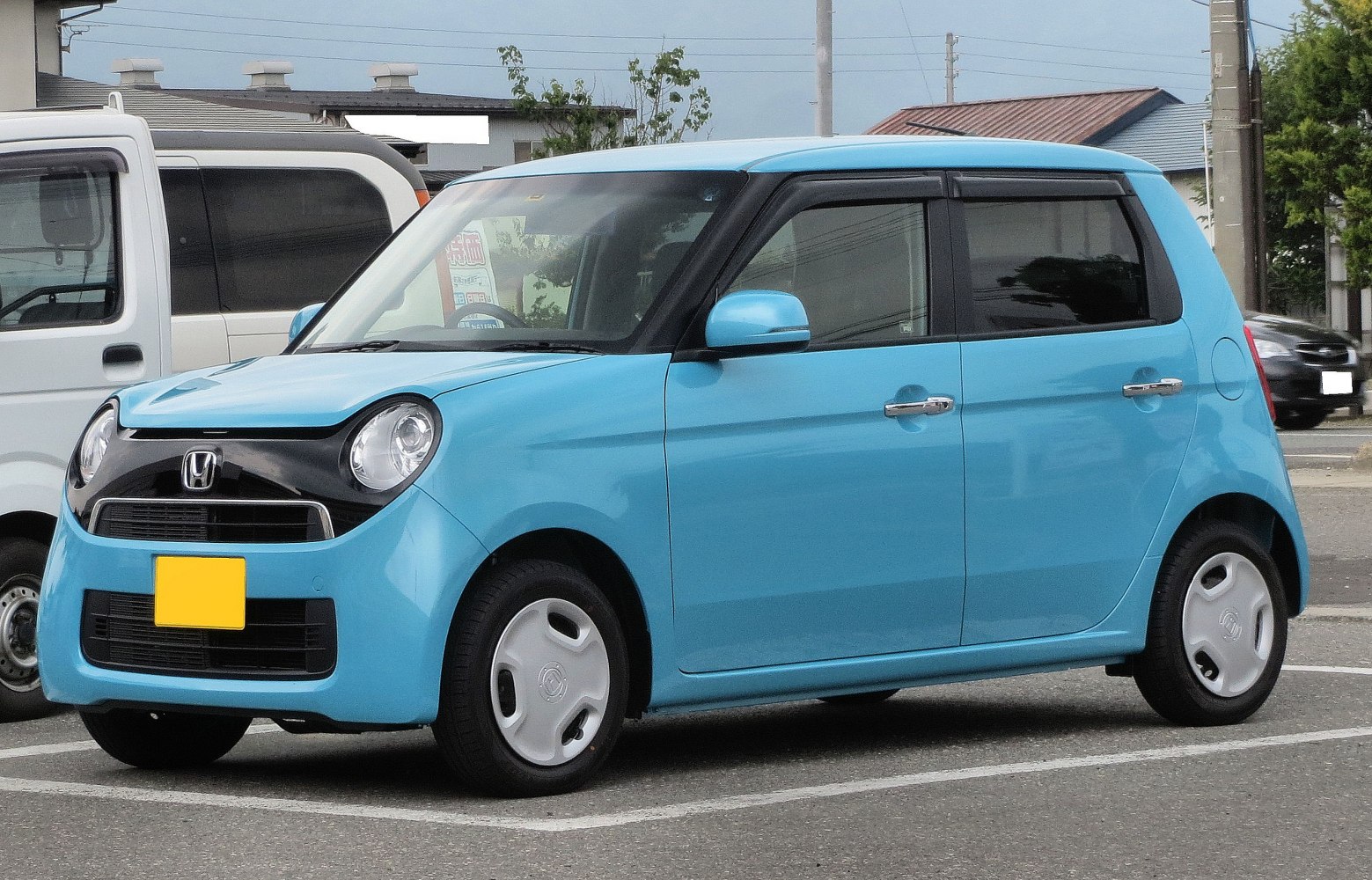 Compact blue kei car with round headlights and black grille
