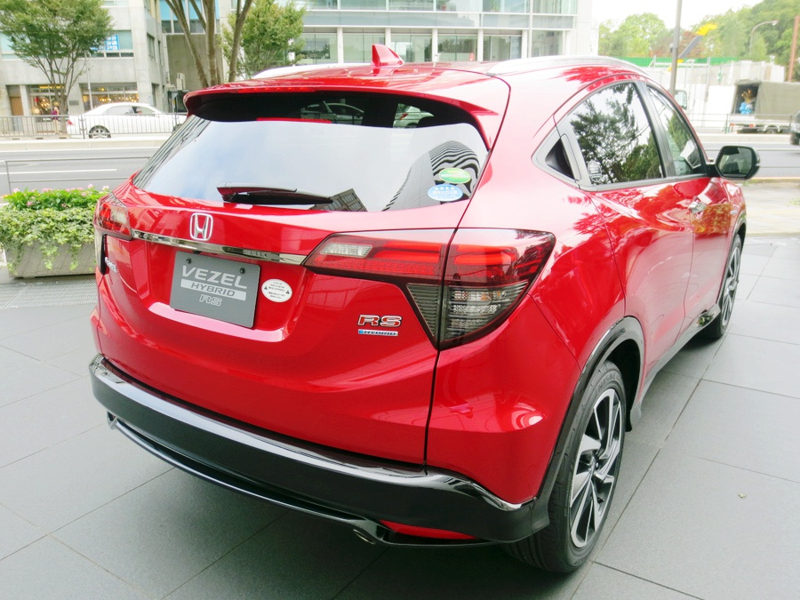 Red SUV rear view with taillights and rear spoiler