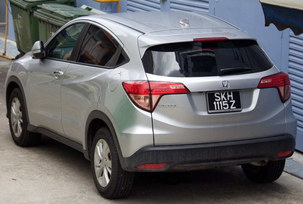 Rear view of silver compact SUV with sharp tail lights and shark fin antenna