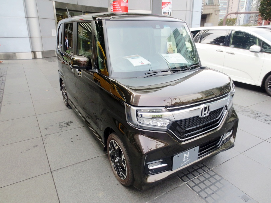 Front view of compact vehicle with distinctive grille and headlights