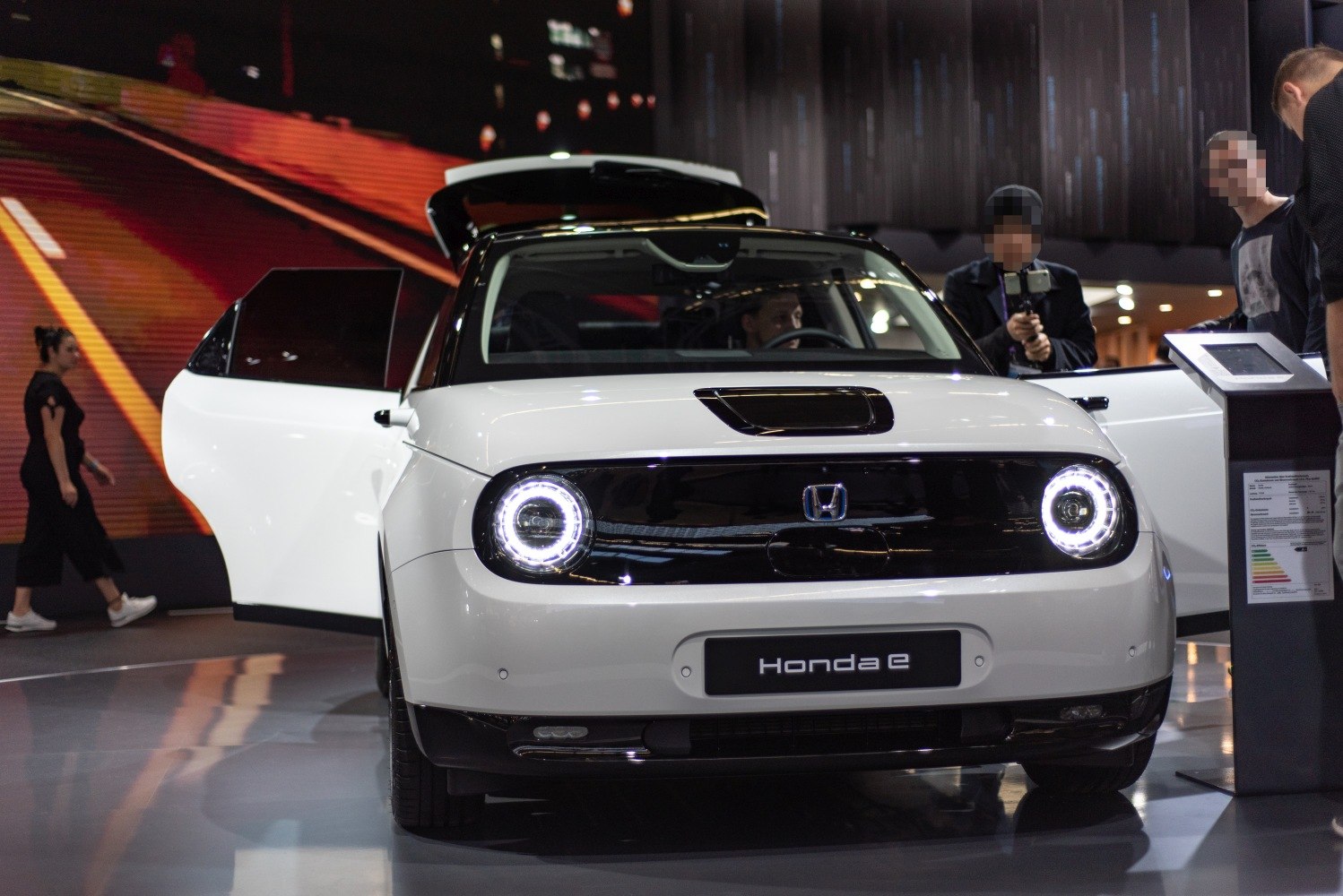 Front view with round LED headlights and black grille