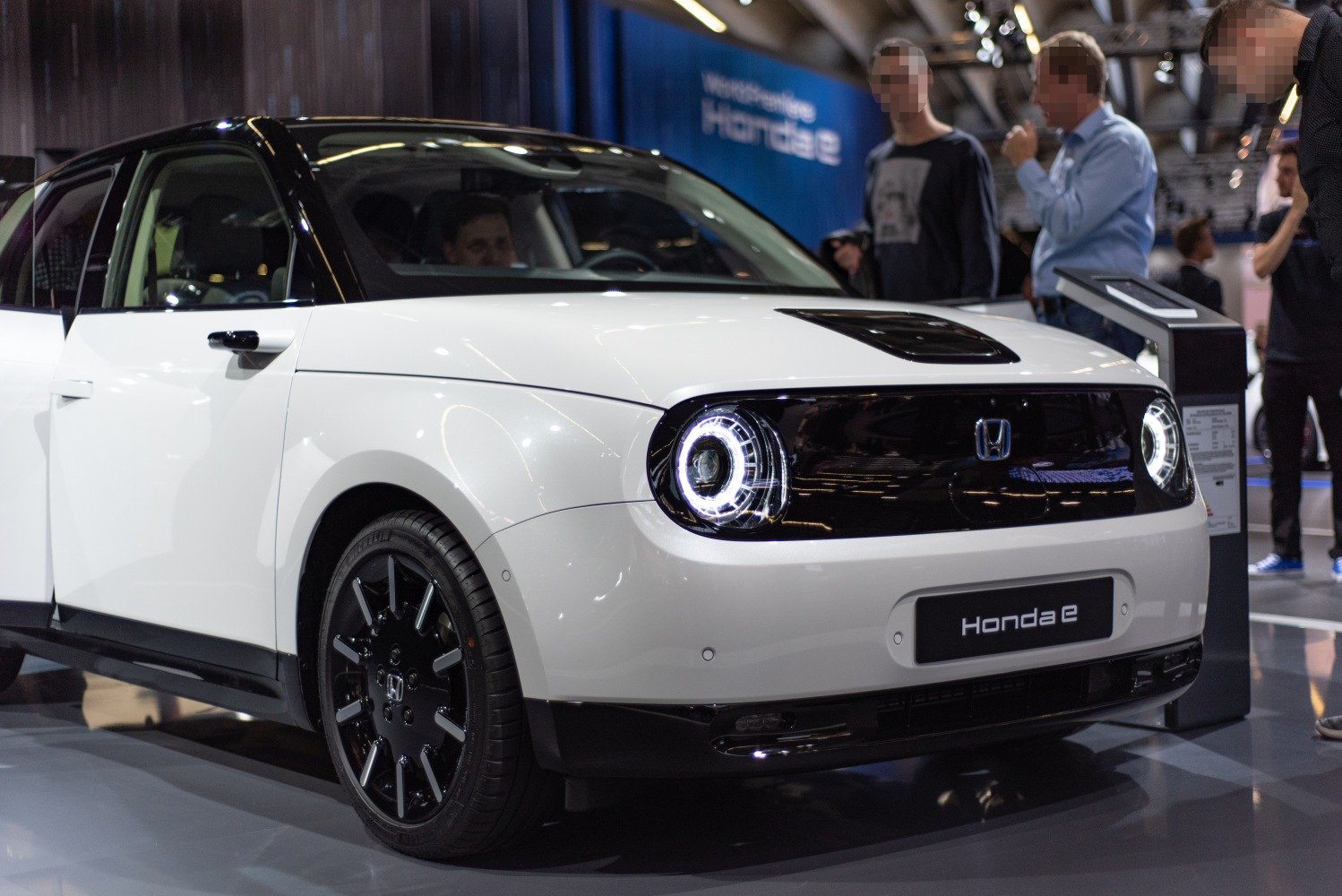 Front view with round LED headlights and black grille
