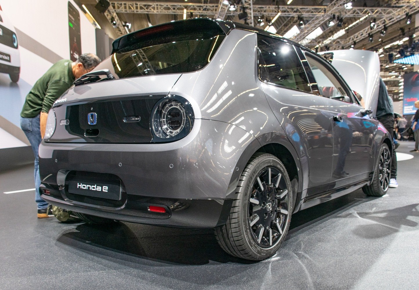 Rear view of electric hatchback with round LED tail lights and black alloy wheels