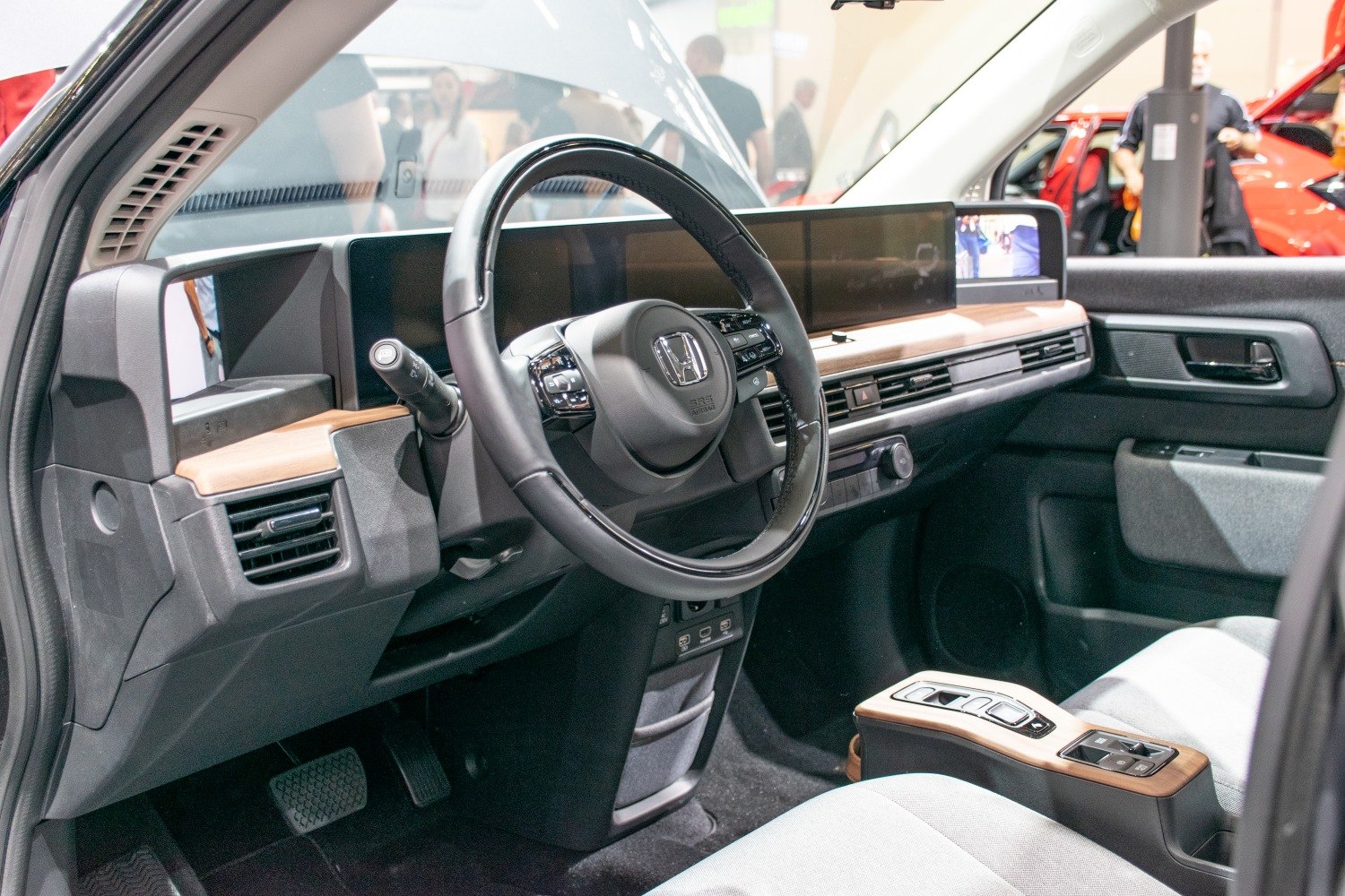Modern dashboard with multifunction steering wheel and wooden trim