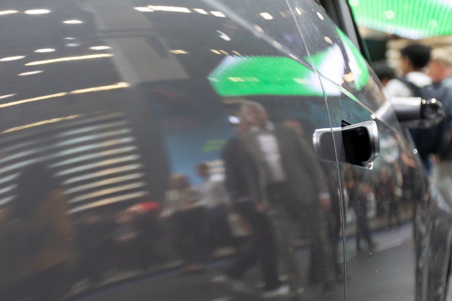 Close-up of electric vehicle side mirror and door handle