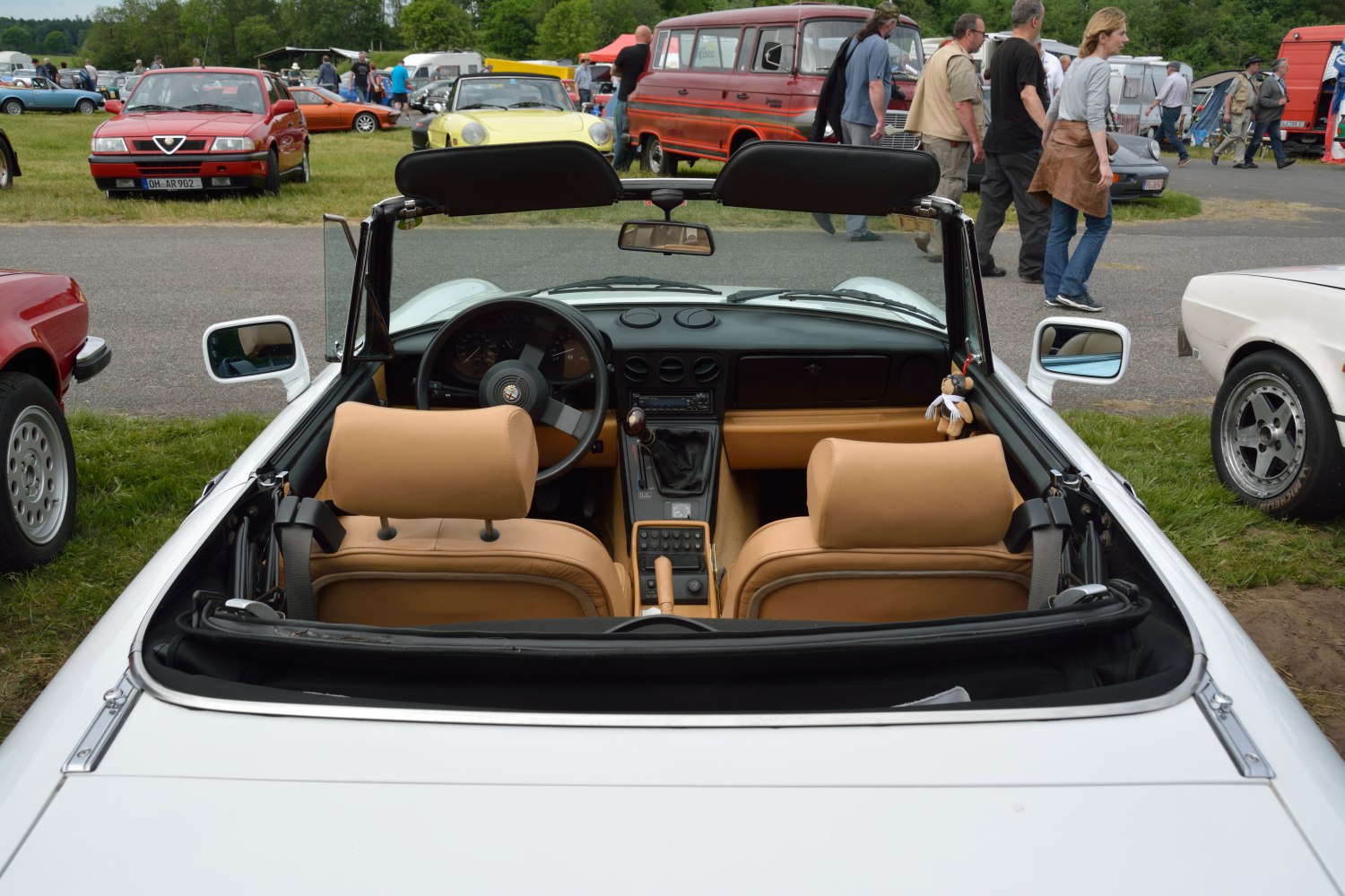 Convertible car with beige leather interior and central dashboard view