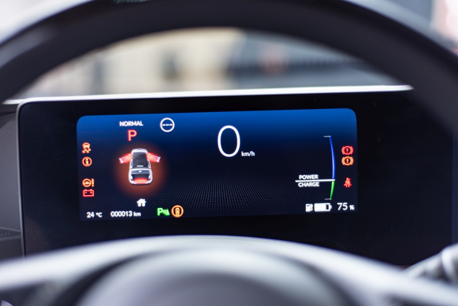Digital instrument cluster with speed, battery charge, and door warning indicators