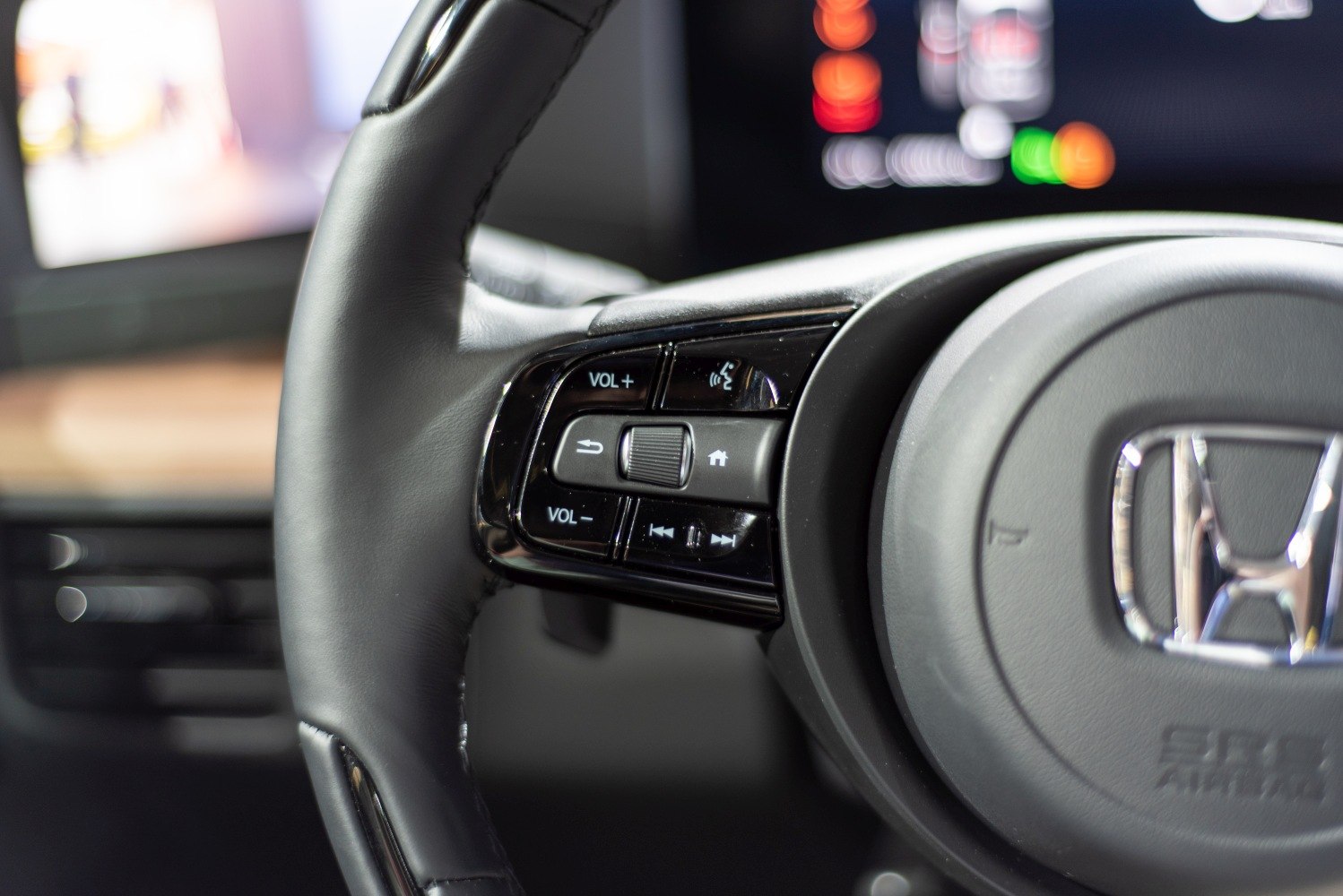 Steering wheel with volume, voice command, and media controls