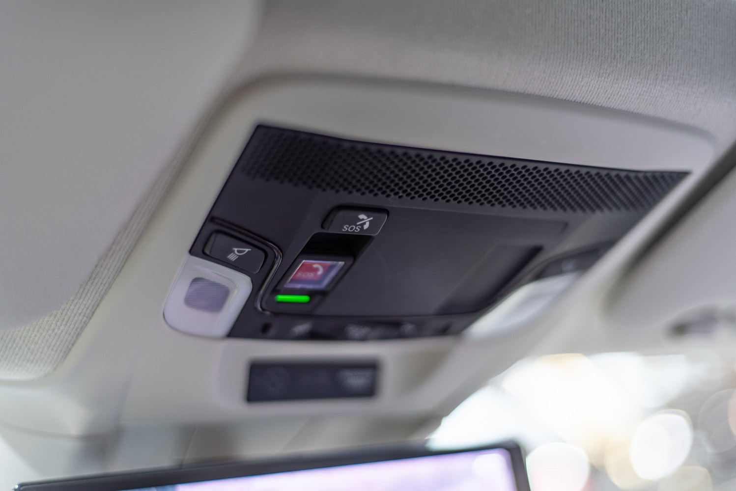Close-up of overhead console with SOS button and light controls
