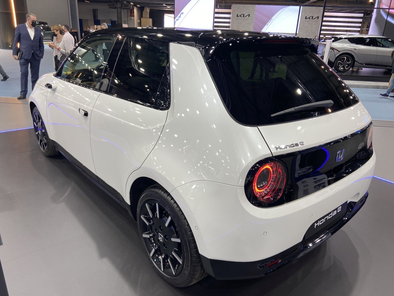 Rear and side view showcasing circular LED taillights and compact hatchback shape.
