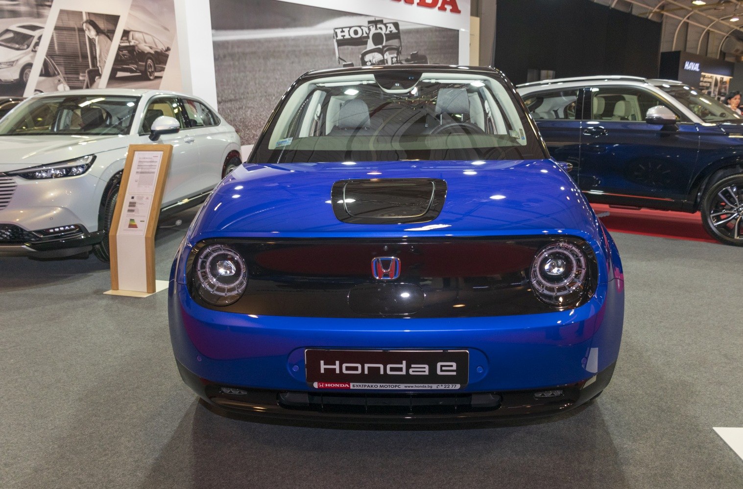 Front view with distinctive round LED headlights and compact design