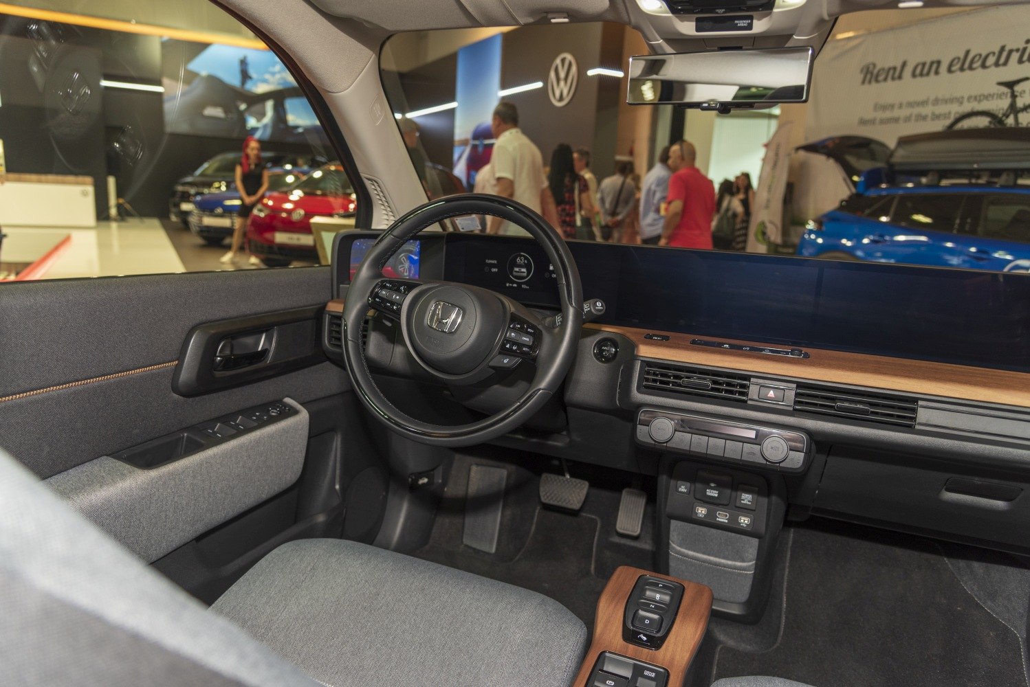 Digital dashboard and minimalist interior with fabric seats and wood accents