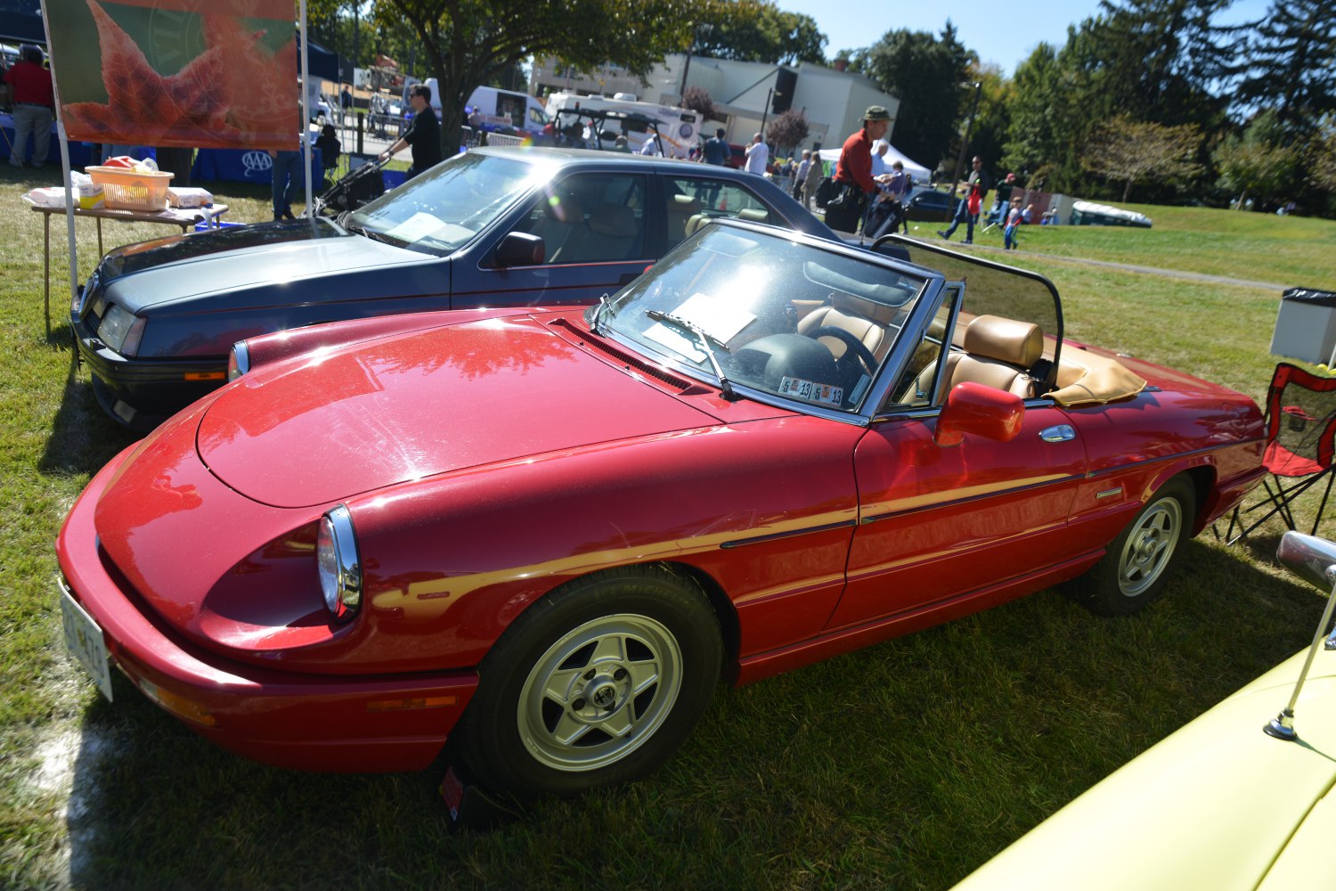 Red convertible with round headlights and alloy wheels