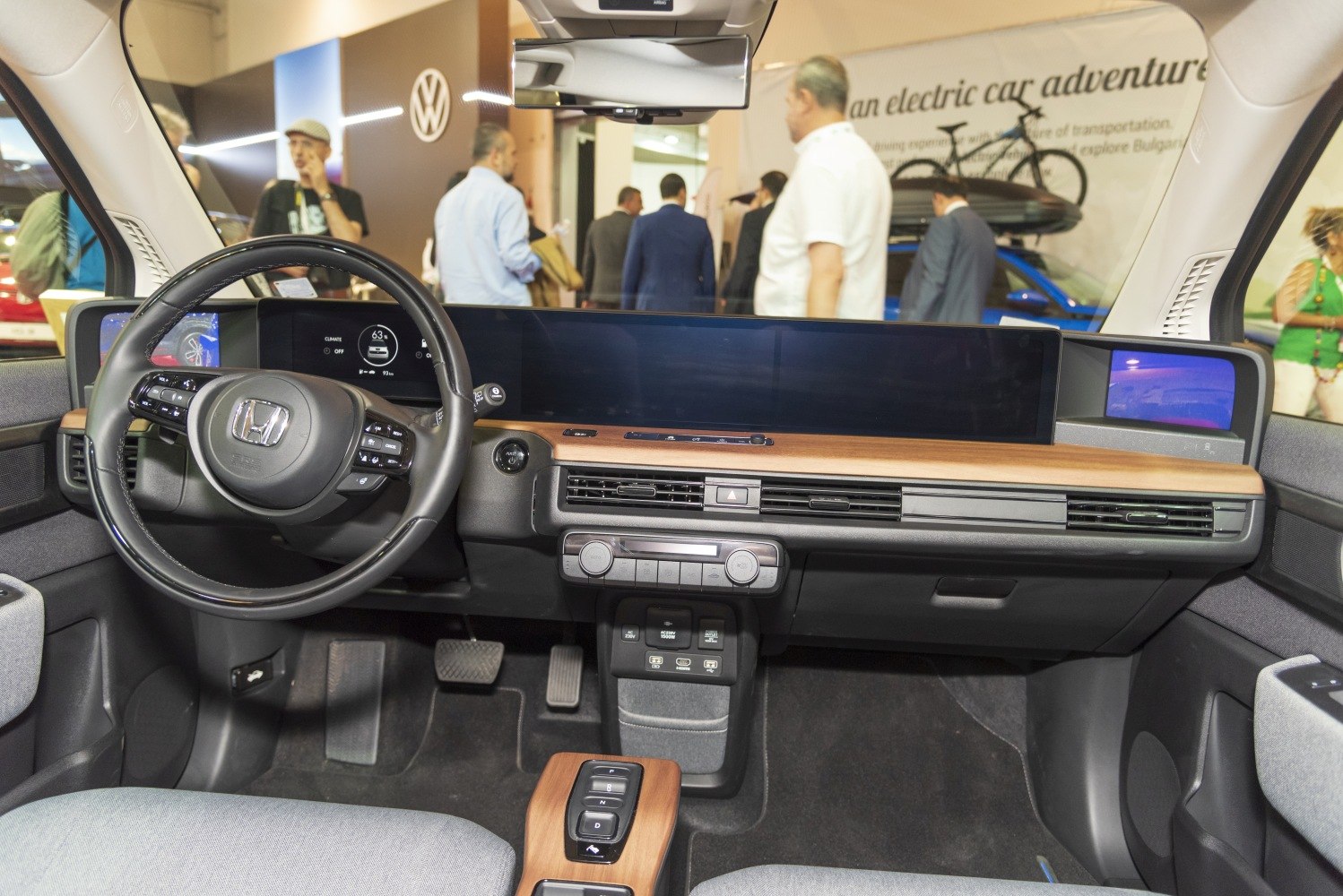 Wide digital dashboard and minimalist interior with wood trim