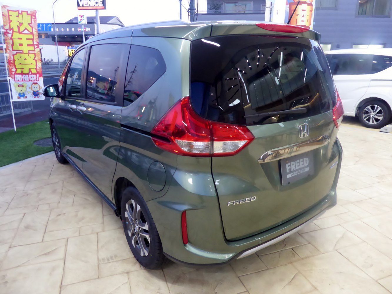 Rear three-quarter view with distinct taillights and aerodynamic body shape.