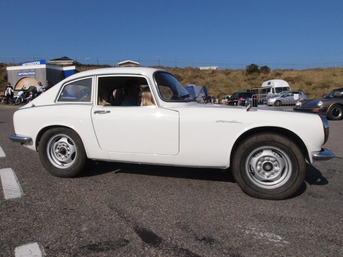 Side profile of white vintage coupe with steel wheels