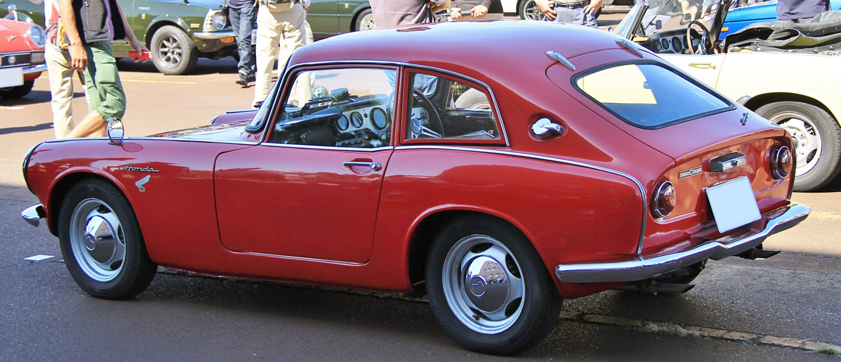 Red classic coupe with distinctive rear side and vintage design.