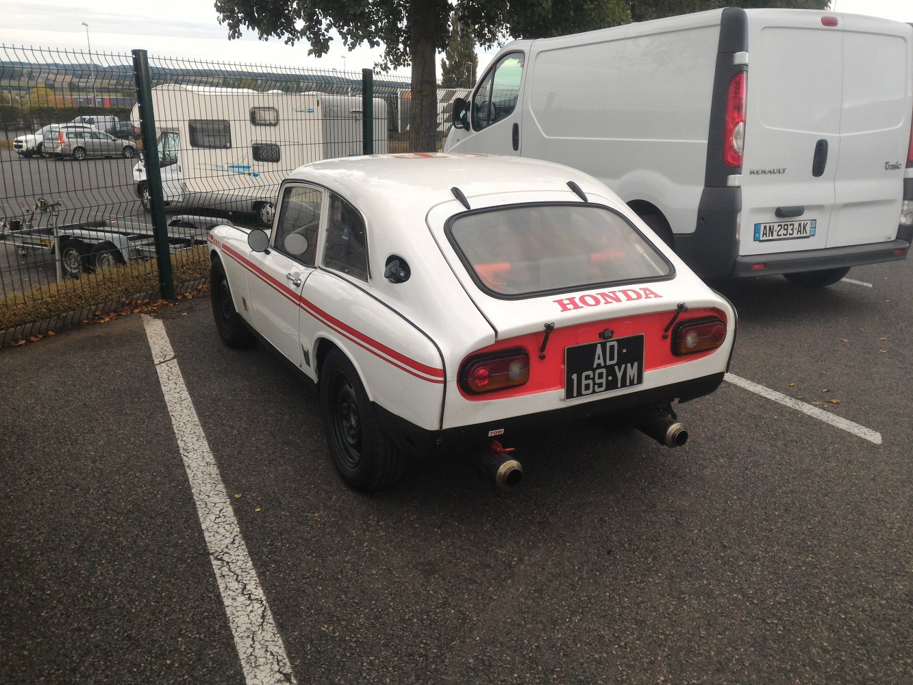 Rear view of a vintage coupe with dual exhaust and distinctive tail lights