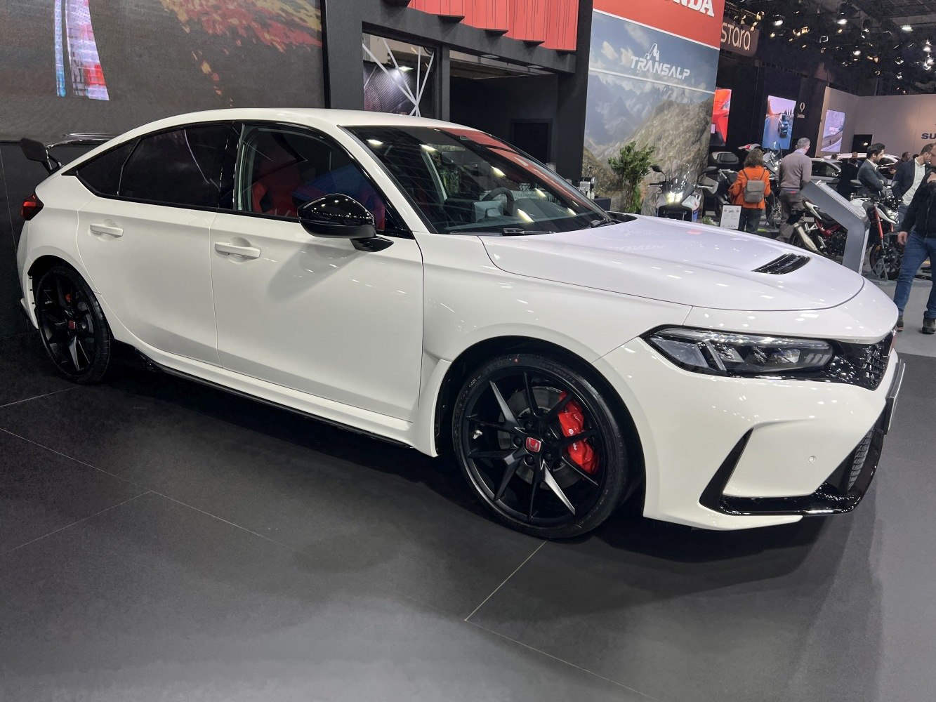 Sporty hatchback with black alloy wheels, red brake calipers and rear wing
