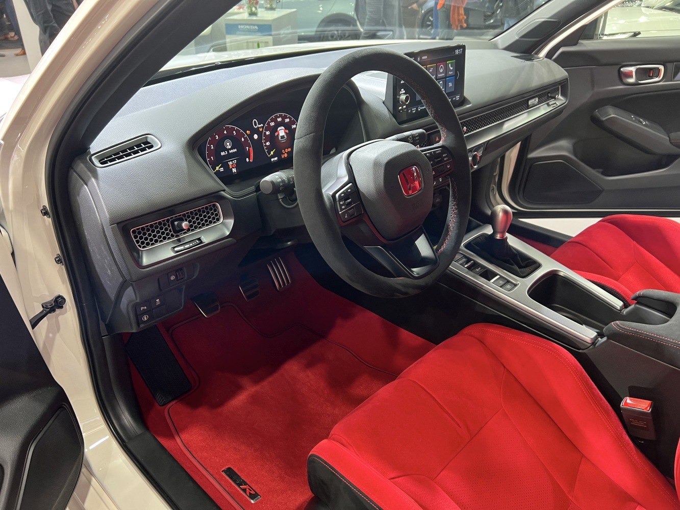 Red sports seats and digital instrument cluster interior with manual gearbox