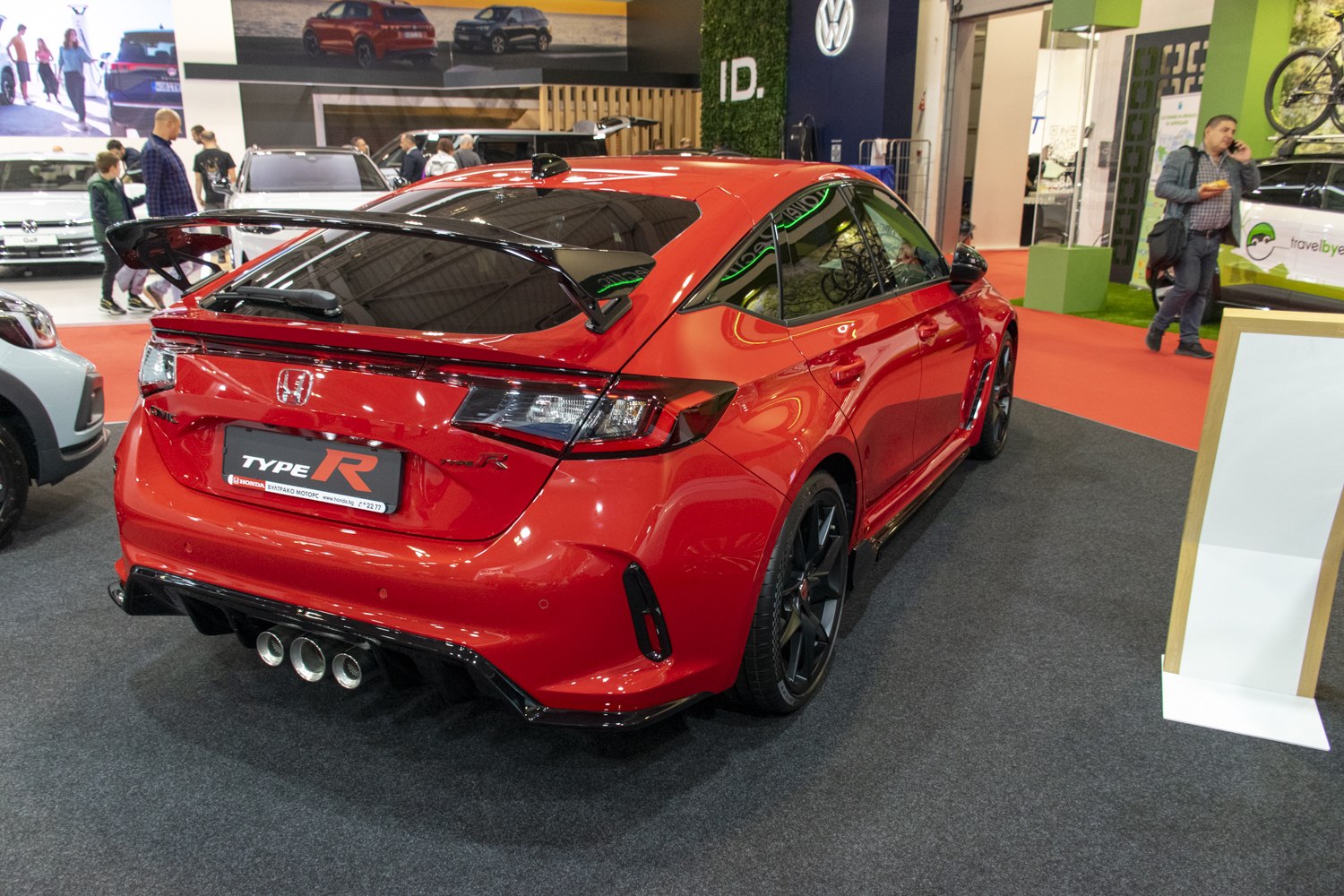 Aggressive rear with large sport spoiler and triple exhaust