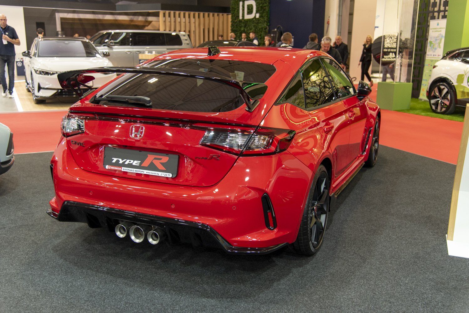 Rear view with triple exhaust and prominent rear spoiler