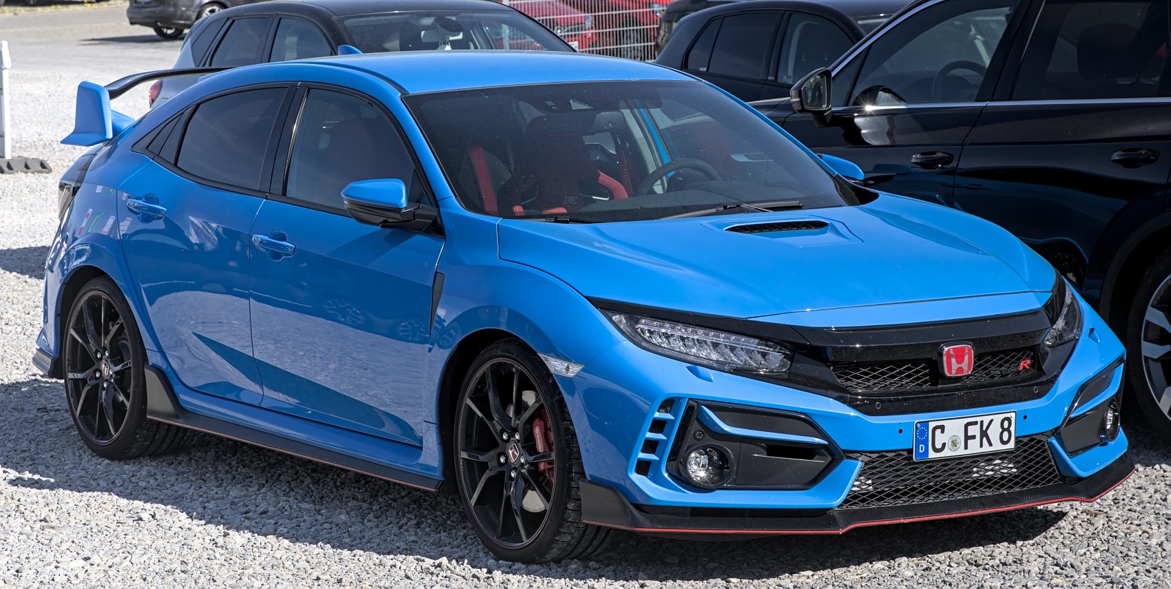 Aggressive front fascia with racing blue paint and sporty rear wing