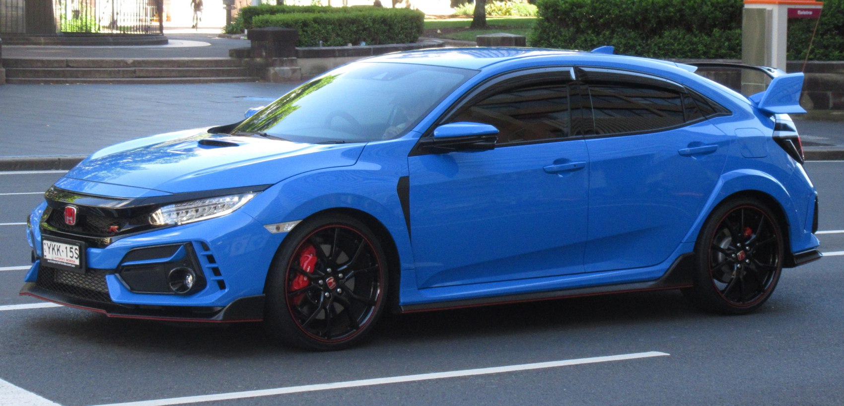 Sporty blue hatchback with aggressive aero and black wheels