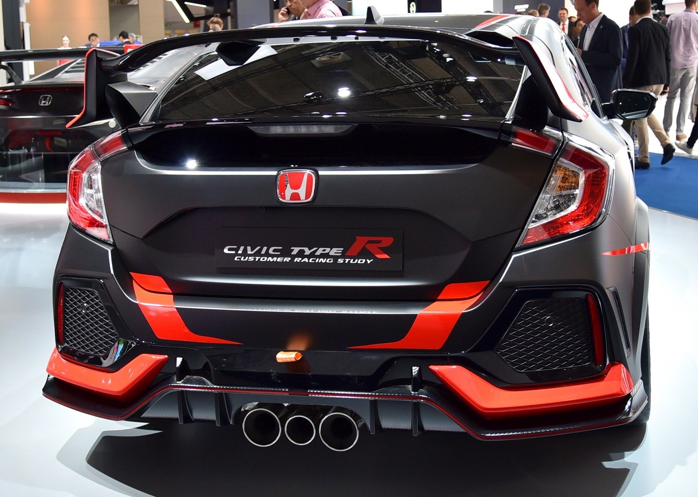 Triple exhaust, rear diffuser, and large rear spoiler at rear view