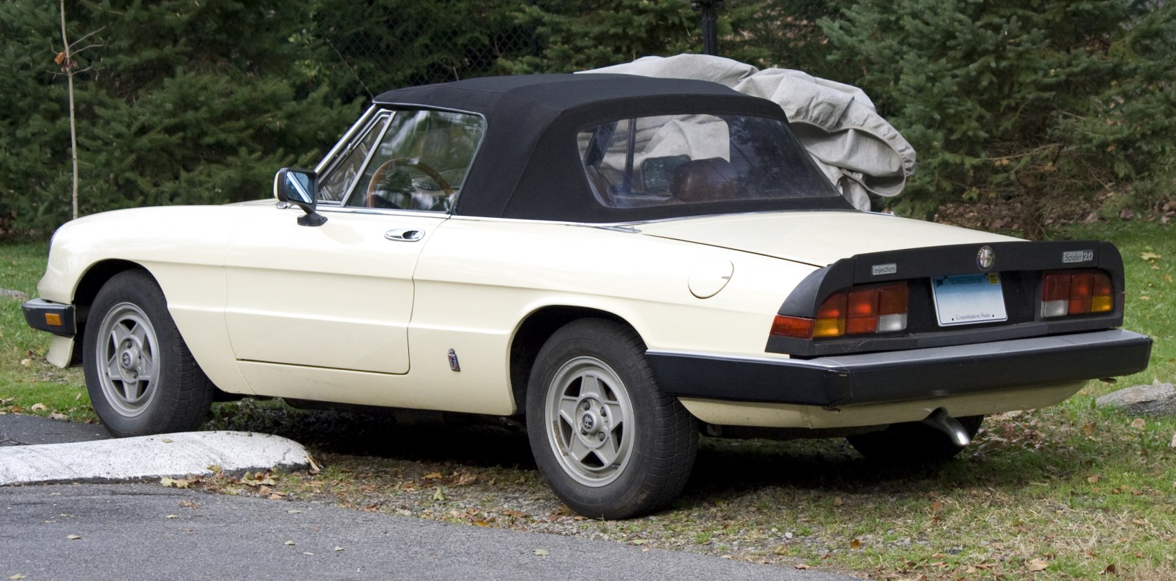 Convertible with black soft top and rectangular rear tail lights