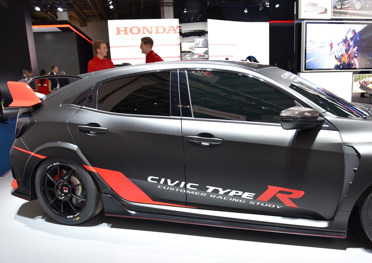 Side view with red-accented spoiler and black wheels