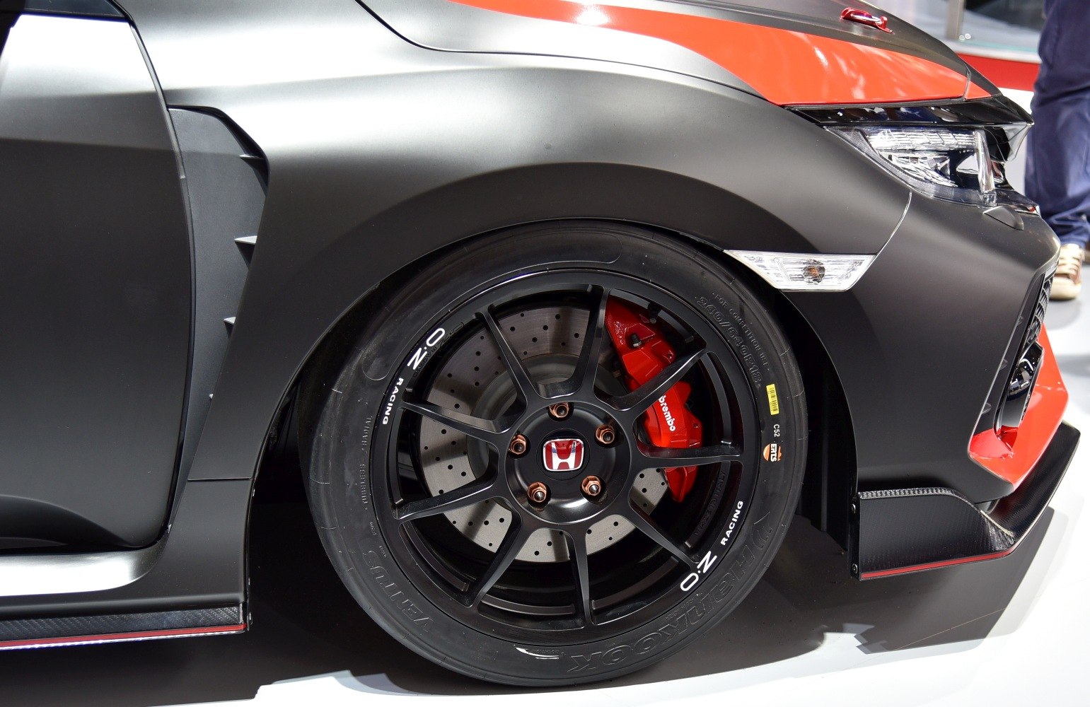 Close-up of front wheel with black OZ Racing rims and red Brembo brakes