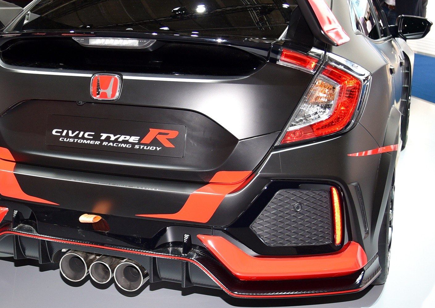 Triple exhaust and distinctive taillight on sporty hatchback rear