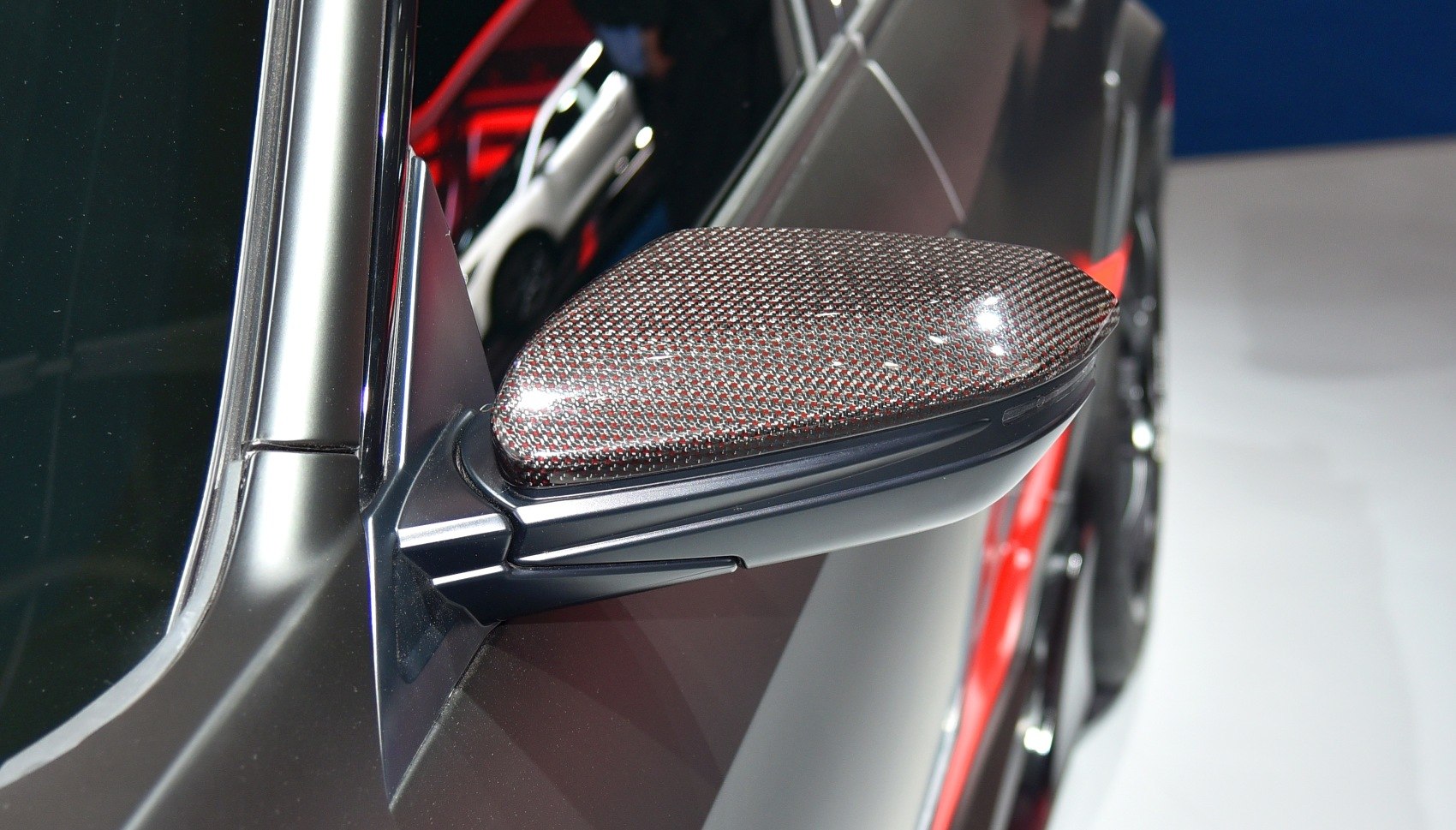 Close-up of carbon fiber side mirror with aerodynamic design