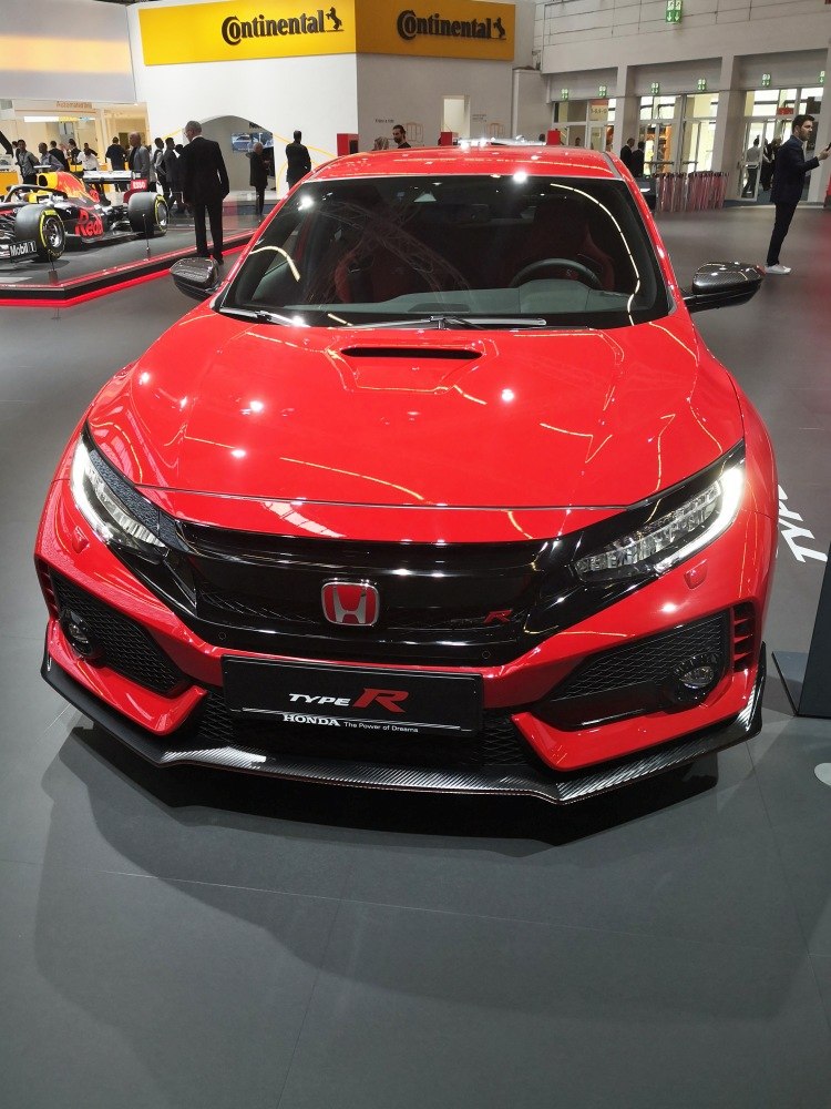 Sporty hatchback front view with aggressive fascia and carbon fiber splitter