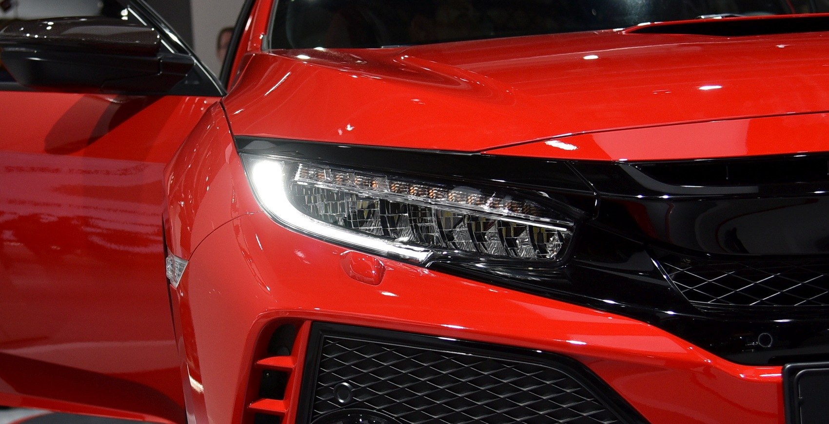 Closeup of LED headlight and aggressive front grille