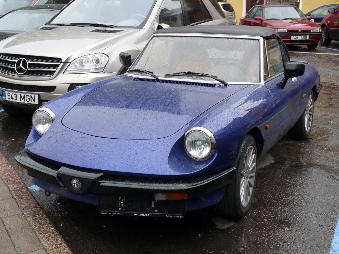 Classic blue convertible with round headlights and sporty front design