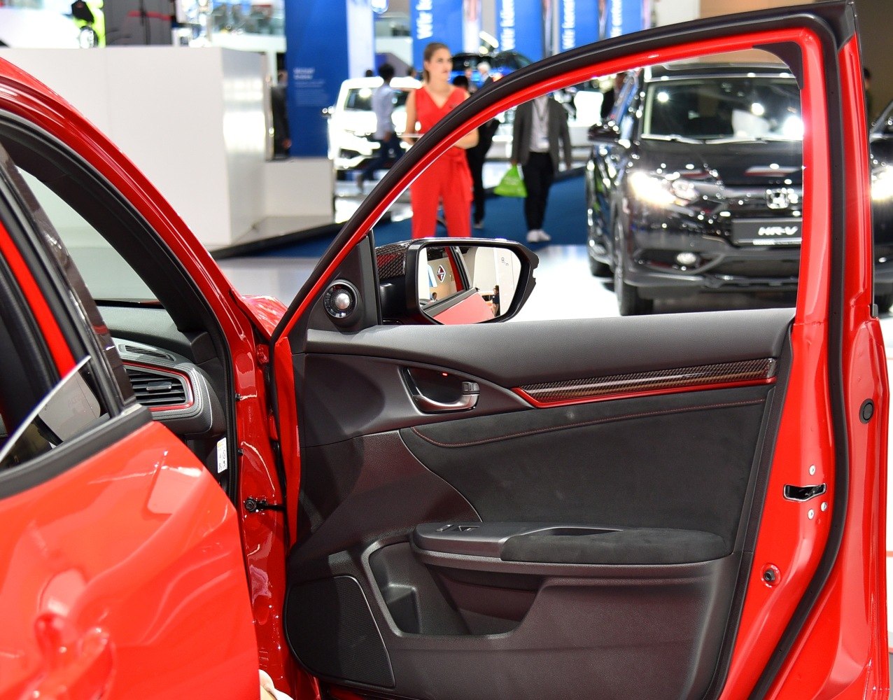 Interior door panel with carbon fiber trim and red accents