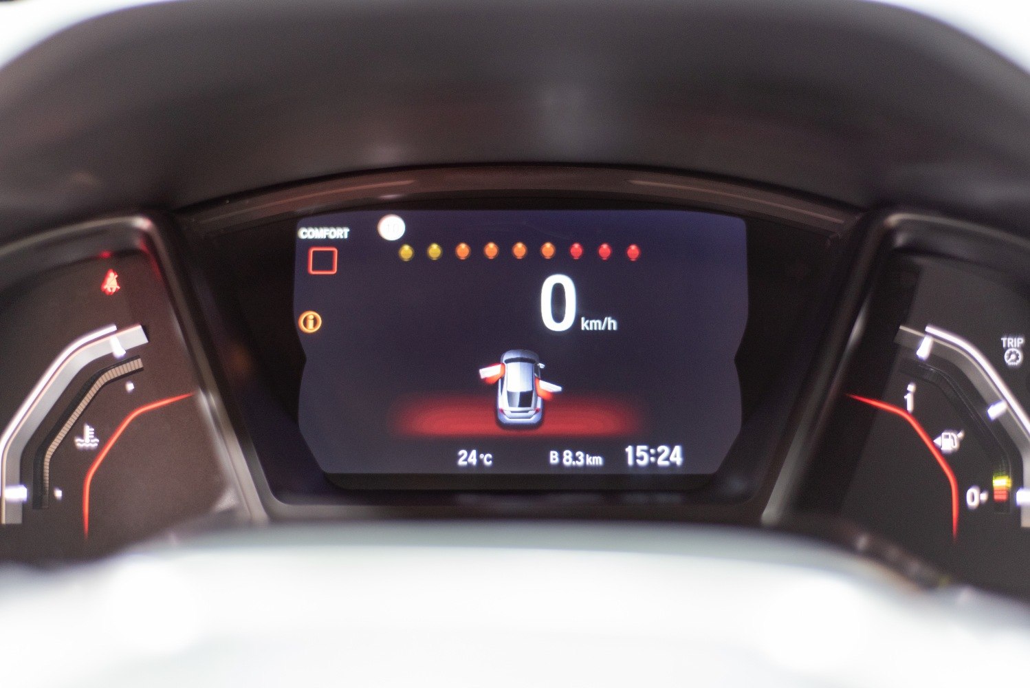 Digital instrument cluster with door open icons and speedometer display